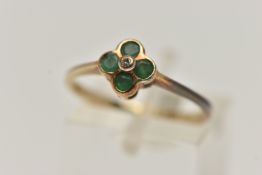 A 9CT GOLD QUATREFOIL EMERALD RING, four circular cut emeralds in a semi bezel setting, accented
