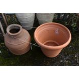 A CYLINDRICAL TAPERED TERRACOTTA POT, diameter 56cm x height 47cm, along with another terracotta pot