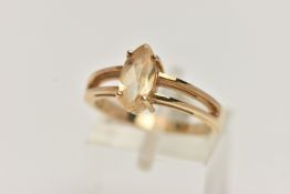 A 9CT GOLD GEM SET RING, a marquise cut citrine prong set in yellow gold, leading on to bifurcated