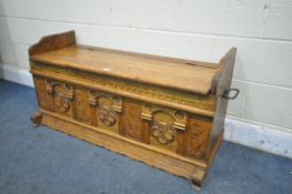 AN EARLY 20TH CENTURY OAK HALL BENCH, with quatrefoil and seahorse panels, and twin handles, width