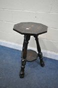A CARVED OAK NONAGONAL TRIPOD TABLE, with an undershelf, diameter 43cm x height 72cm (condition
