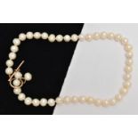 A CULTURED PEARL NECKLACE, a string of baroque cultured pearls, fitted with a yellow gold toggle