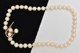 A CULTURED PEARL NECKLACE, a string of baroque cultured pearls, fitted with a yellow gold toggle