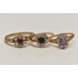 THREE 9CT GOLD GEM SET RINGS, to include a heart shape sapphire and cubic zirconia cluster ring (one
