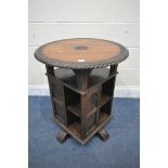 A LATE 19TH CENTURY CARVED OAK REVOLVING BOOKCASE, the circular top over an undershelf and a base