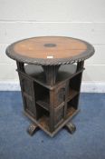 A LATE 19TH CENTURY CARVED OAK REVOLVING BOOKCASE, the circular top over an undershelf and a base