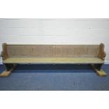 A LONG 19TH CENTURY PINE CHURCH PEW, length no including later raised bases 297cm (condition report: