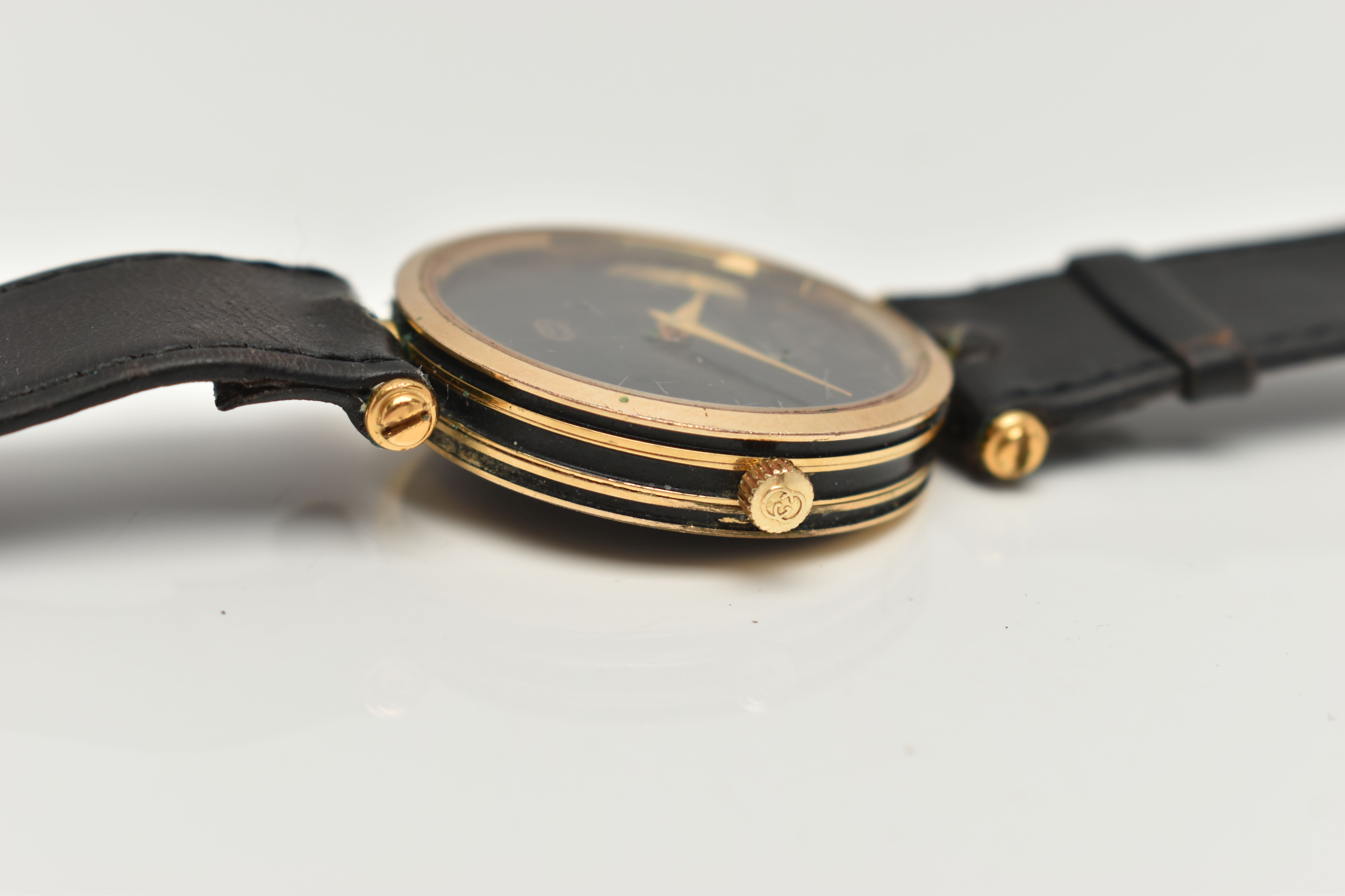A VINTAGE LADYS GOLD PLATED QUARTZ GUCCI WRISTWATCH, round black dial signed Gucci, case width - Image 6 of 6