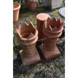 A PAIR OF TERRACOTTA CHIMNEY POTS, diameter 33cm x height 74cm, along with another terracotta