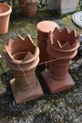 A PAIR OF TERRACOTTA CHIMNEY POTS, diameter 33cm x height 74cm, along with another terracotta