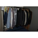 ONE RAIL OF GENTLEMEN'S SUITS, JACKETS AND SHIRTS, to include three well-worn leather jackets, a
