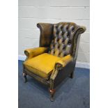 A MUSTARD YELLOW LEATHER CHESTERFIELD WING BACK ARMCHAIR, on cabriole legs, width 80cm x depth