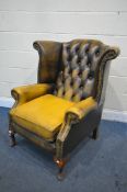 A MUSTARD YELLOW LEATHER CHESTERFIELD WING BACK ARMCHAIR, on cabriole legs, width 80cm x depth