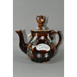 A BARGEWARE TEAPOT, having brown treacle glaze, sprigged peacock and floral decoration, plaque