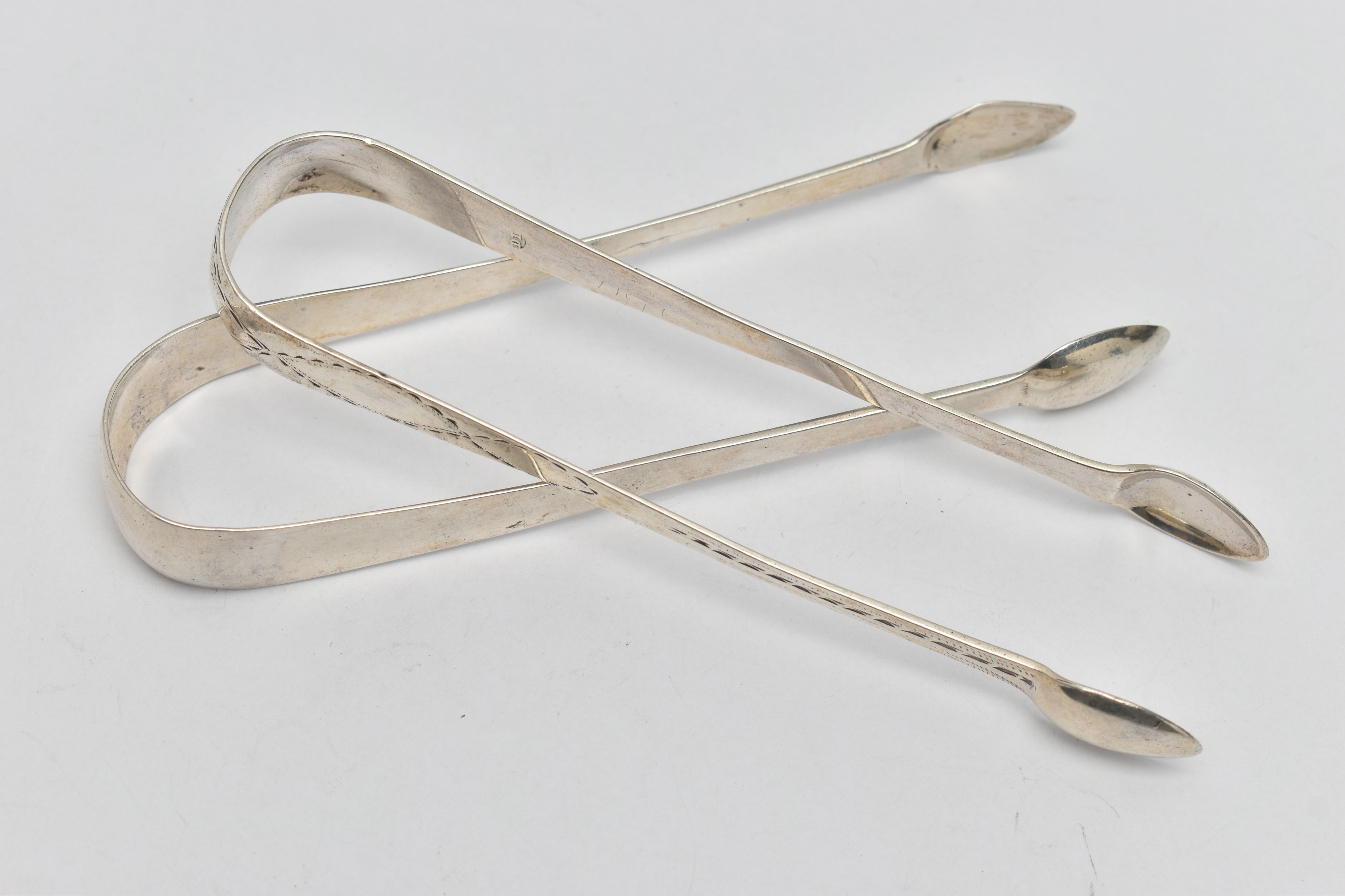 TWO PAIRS OF SILVER SUGAR TONGS, the first pair a plain polished pair of sugar tongs, hallmarked '