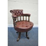 AN EARLY 20TH CENTURY MAHOGANY BUTTONED BURGUNDY SWIVEL OFFICE CHAIR (condition report: -swivel