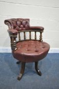 AN EARLY 20TH CENTURY MAHOGANY BUTTONED BURGUNDY SWIVEL OFFICE CHAIR (condition report: -swivel