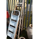 FOUR SETS OF STEP LADDERS, to include an aluminium ladder, and three sized wooden ladders, tallest