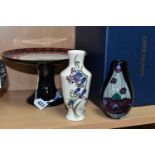 THREE PIECES OF MOORCROFT POTTERY, comprising a boxed Alice in Wonderland collection cake stand,