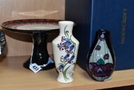 THREE PIECES OF MOORCROFT POTTERY, comprising a boxed Alice in Wonderland collection cake stand,