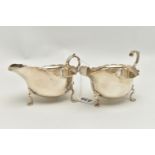 A PAIR OF GEORGE V SILVER SAUCEBOATS, of oval form with wavy rims, S scroll handles, on three