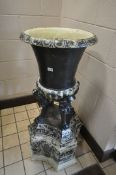 A CAST IRON CAMPAGNA URN, the urn top supported on four mythical creatures, and base with masks,