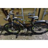 A BLACK FLYING MOUNTAIN BIKE, with green and white details, a 17 inch frame and shimano gears (