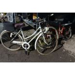 A VINTAGE APOLLO PROVENCE, with two spare tyres, along with a vintage red Raleigh Twenty (
