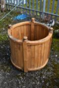 A WOODEN CYLINDRICAL GARDEN PLANTER, diameter 76cm x height 74cm (condition - ideal for