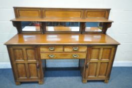 AN EARLY 20TH CENTURY WALNUT PEDESTAL SIDEBOARD, with a raised mirror back and shelf, panel cupboard
