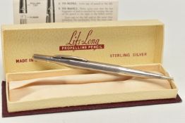 A BOXED WHITE METAL 'LIFE-LONG' PROPELLING PENCIL, engine turned pattern, stamped 'Sterling