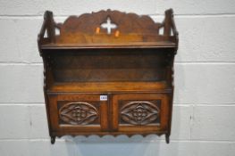 AN EARLY 20TH CENTURY OAK ECCLESIASTICAL WALL CABINET, with two carved panelled cupboard doors,