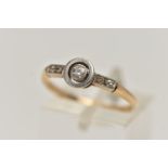 A YELLOW METAL DIAMOND RING, central old cut diamond, collet set in a white metal mount, flanked