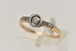 A YELLOW METAL DIAMOND RING, central old cut diamond, collet set in a white metal mount, flanked