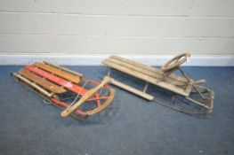 A VINTAGE WOODEN AND METAL SLEDGE, with steering and brakes, along with a vintage flyer sledge (