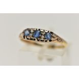 A YELLOW METAL GEM SET RING, three oval cut blue topaz and four old cut diamonds prong set in yellow