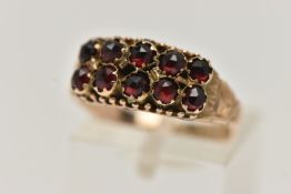 A LATE VICTORIAN 9CT GOLD GARNET RING, designed with two rows of five rose cut garnets, to a