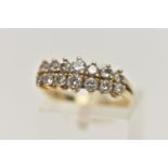 AN 18CT GOLD DIAMOND RING, designed with two rows of graduated round brilliant cut diamonds,