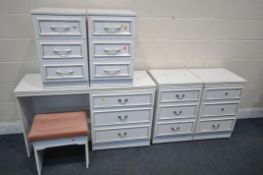 A WHITE FINISH BEDROOM SUITE, comprising a dressing table, two pair of three drawer bedside