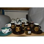 A SMALL COLLECTION OF DENBY COFFEE AND BREAKFAST WARE IN GREEN WHEAT AND ARABESQUE PATTERNS, the