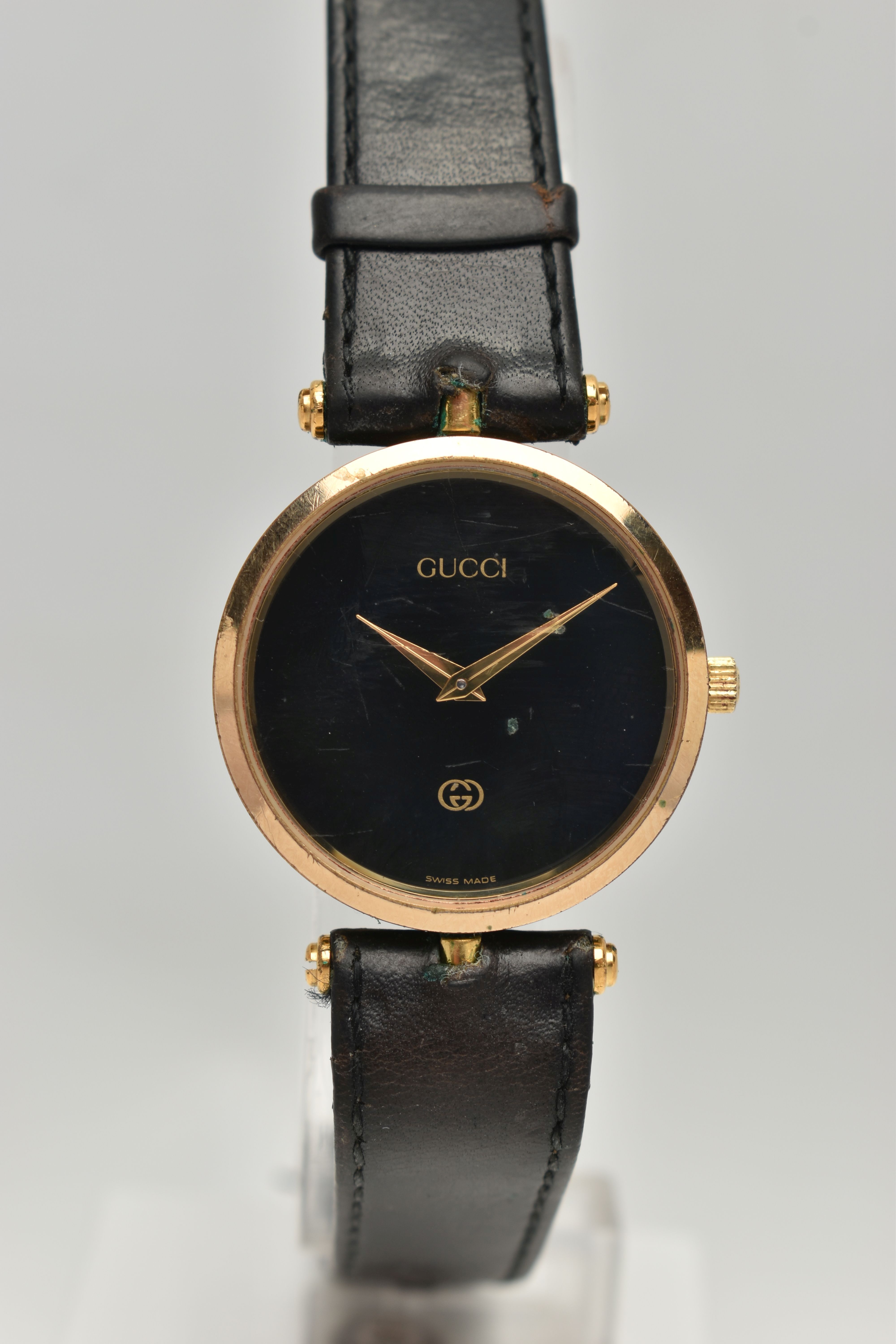 A VINTAGE LADYS GOLD PLATED QUARTZ GUCCI WRISTWATCH, round black dial signed Gucci, case width