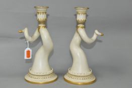 A PAIR OF ROYAL WORCESTER PORCELAIN CANDLESTICKS, in the form of twisted animal horns, each