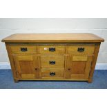 A GOLDEN SOLID OAK SIDEBOARD, with five drawers, and panelled cupboard doors, width 139cm x depth