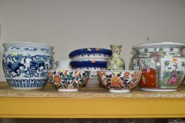 A GROUP OF EIGHT ORIENTAL STYLE PLANTERS AND BOWLS, comprising a large blue and white planter