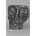 A CARVED AFRICAN GREEN GRANITE STYLISED MALE FACE, polished to the front, the sides and back left