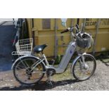 A POWABYKE ELECTRIC BIKE, with front and rear basket, a spare basket, two chargers, two pumps and