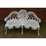 A WHITE PAINTED CAST ALUMINIUM THREE SEATER GARDEN BENCH, two backrests flanking a central