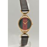 A 'GUCCI' WRISTWATCH, quartz movement, red and green round dial, signed 'Gucci', yellow metal