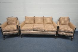 A LATE 19TH/EARLY 20TH CENTURY MAHOGANY THREE PIECE LOUNGE SUITE, with cross patterned fabric, on