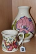 A MOORCROFT POTTERY MUG AND VASE, comprising a 'Butterfly' mug designed by Rachel Bishop, tube lined